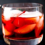 Boulevardier Cocktail with ice and cherries in a glass