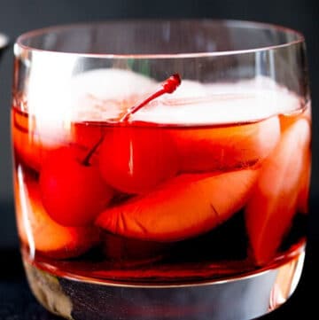 Boulevardier Cocktail with ice and cherries in a glass