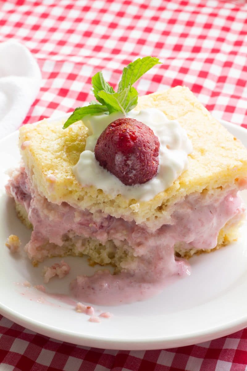 Strawberry Shortcake Cake on white plate and red gingham tablecloth