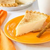 Sugar Cream Pie and cinnamon sticks on orange plate