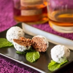 Chocolate Bourbon Ball and mint on a square plate