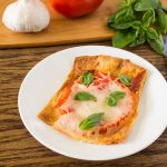 Margherita Pizza Slice on white plate