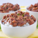 Red beans and sausage over rice in a white bowls