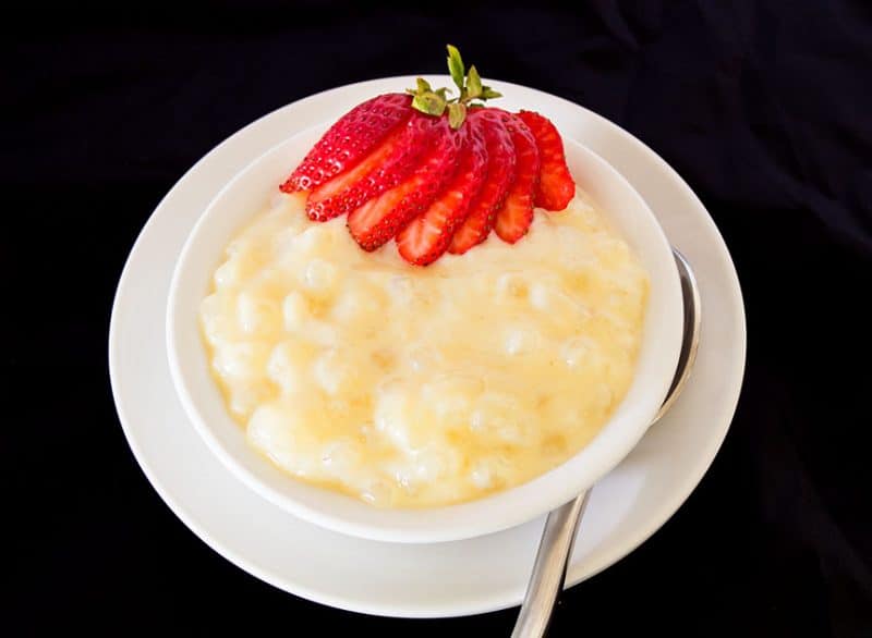 Large pearl tapioca pudding in white bowl with strawberry on top