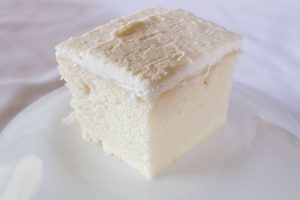 White wedding cake with white icing on a white plate
