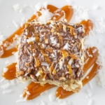 Eclair cake topped with coconut and caramel