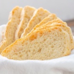 Cloth lined basket with slices of homemade bread