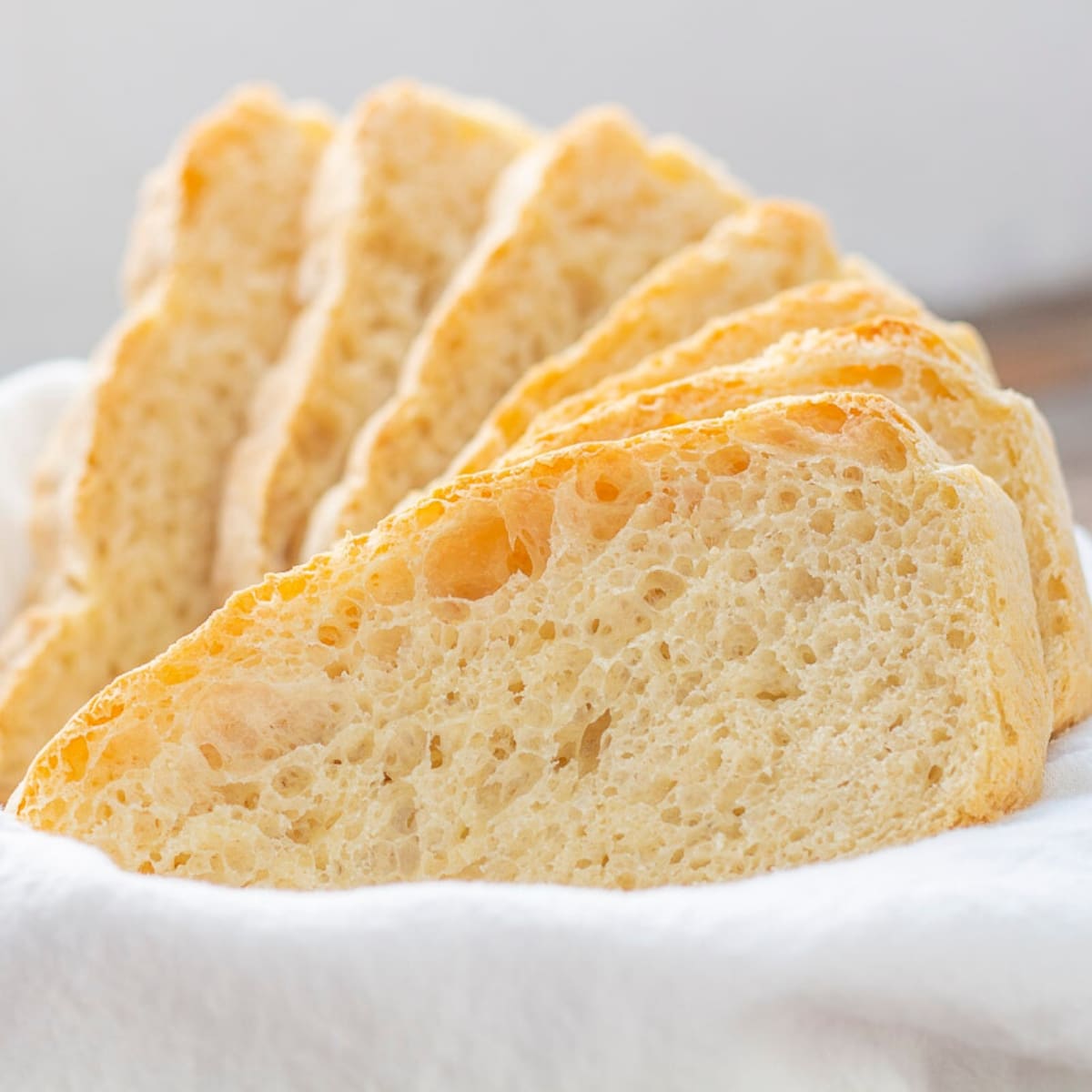 Cloth lined basket with slices of homemade bread