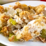 Bread stuffing with celery and onions on a white plate