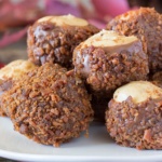 Bacon covered chocolate coated peanut balls on a plate