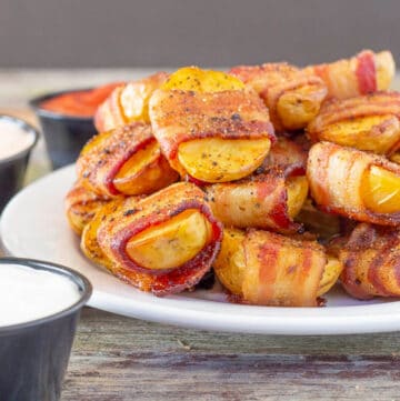 Bacon Wrapped Potatoes stacked on a plate