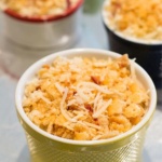 Jalapeno Popper Dip covered with cracker crumbs and cheese in a ramekin