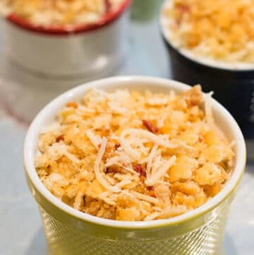 Jalapeno Popper Dip covered with cracker crumbs and cheese in a ramekin