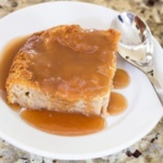 New Orleans Style Bread Pudding on white plate with spoon