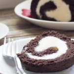 Ice Cream Cake roll slice in white plate with fork