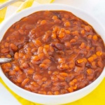 Bowl of baked beans on a yellow napkin
