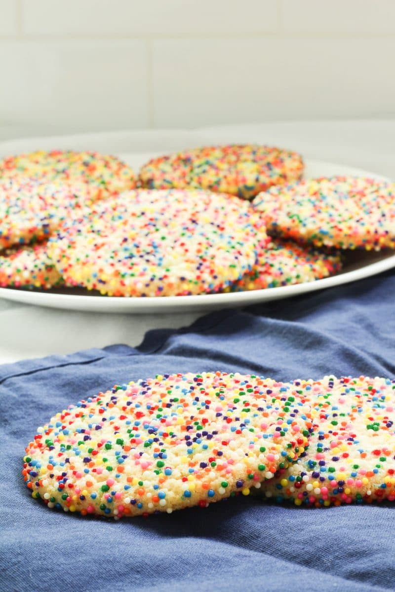 Soft and chewy sprinkle cookies are easy to make and beautiful to look at. Color coordinate to match the holiday or party theme. #recipe #cookie #birthday #sprinkles #party #kidfriendly #beginner