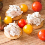 CHicken Salad on crackers surrounded by tomatoes