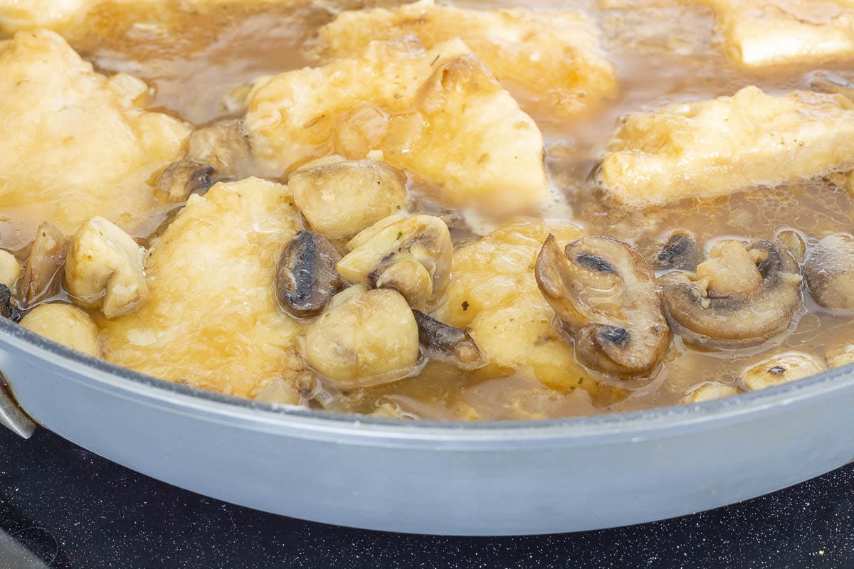 Chicken and mushrooms simmering in Marsala sauce