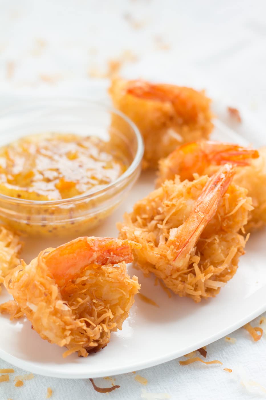 Coconut Shrimp with dipping sauce ona white plate
