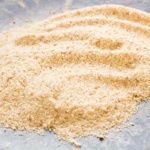 Homemade breadcrumbs on a baking sheet