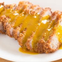 sliced breaded and fried pork chop covered with creole honey mustard