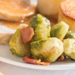 Brussels sprouts with bacon on a plate with potatoes and prok
