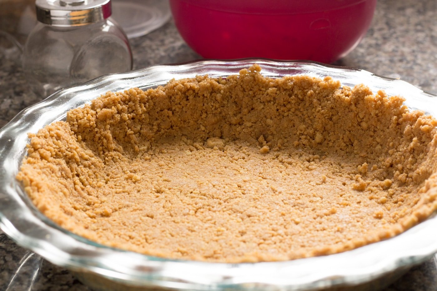 Peanut butter cookie crust in a glass pan