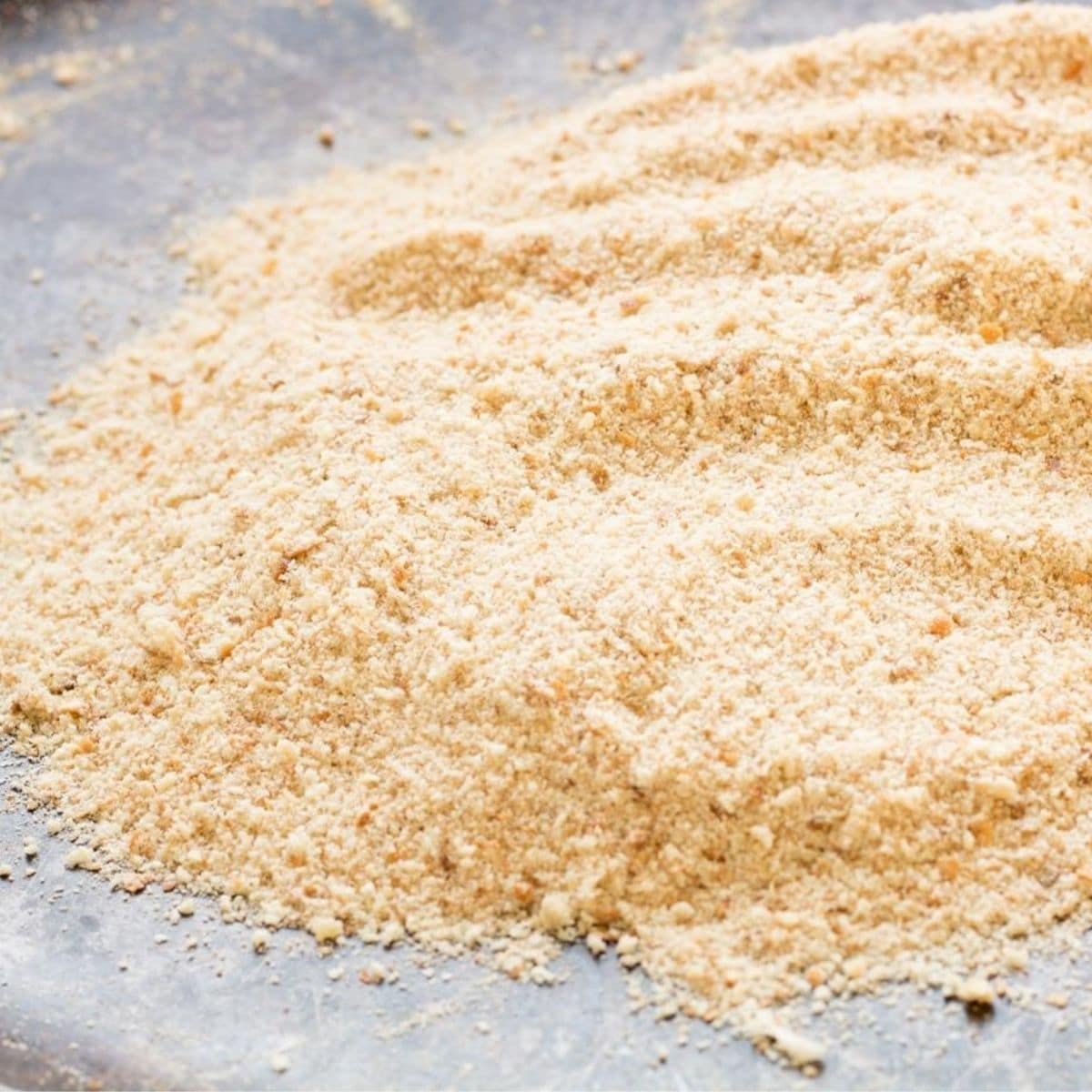Homemade breadcrumbs on a baking sheet