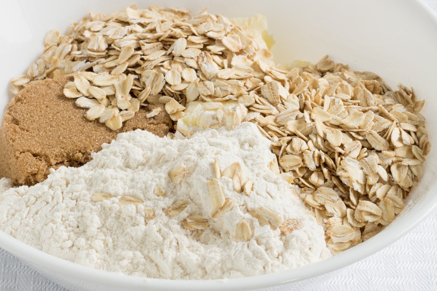 Dark brown sugar flour oats and butter in a bowl