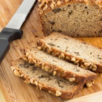 Banana bread with nuts on a cutting board