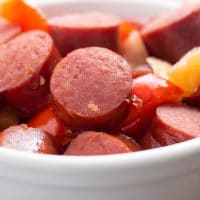 Sweet and Sour Kielbasa with peppers and pineapples in a bowl