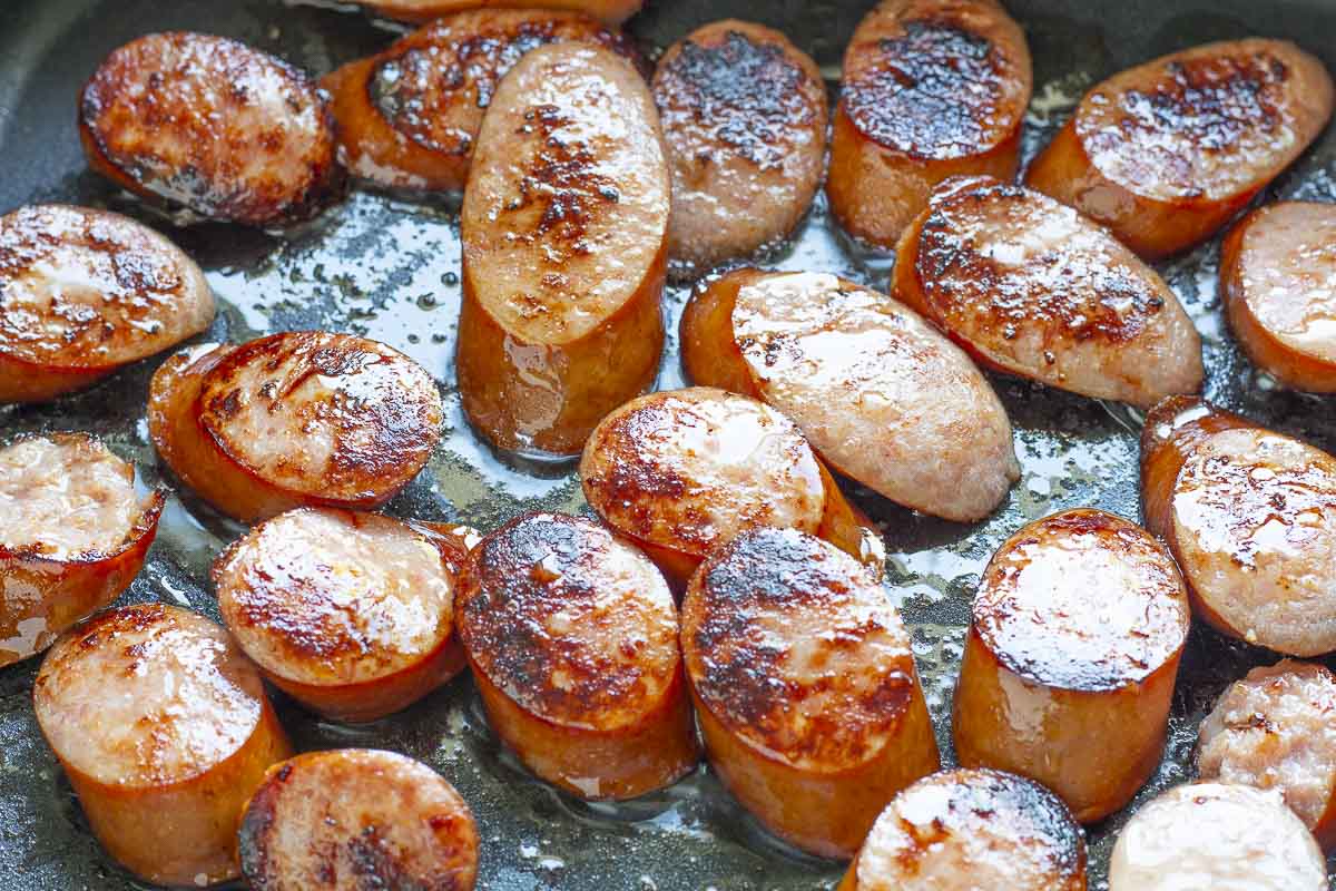 Browned kielbasa slices in a skillet
