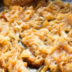 Caramelized onions cooking in an electric skillet