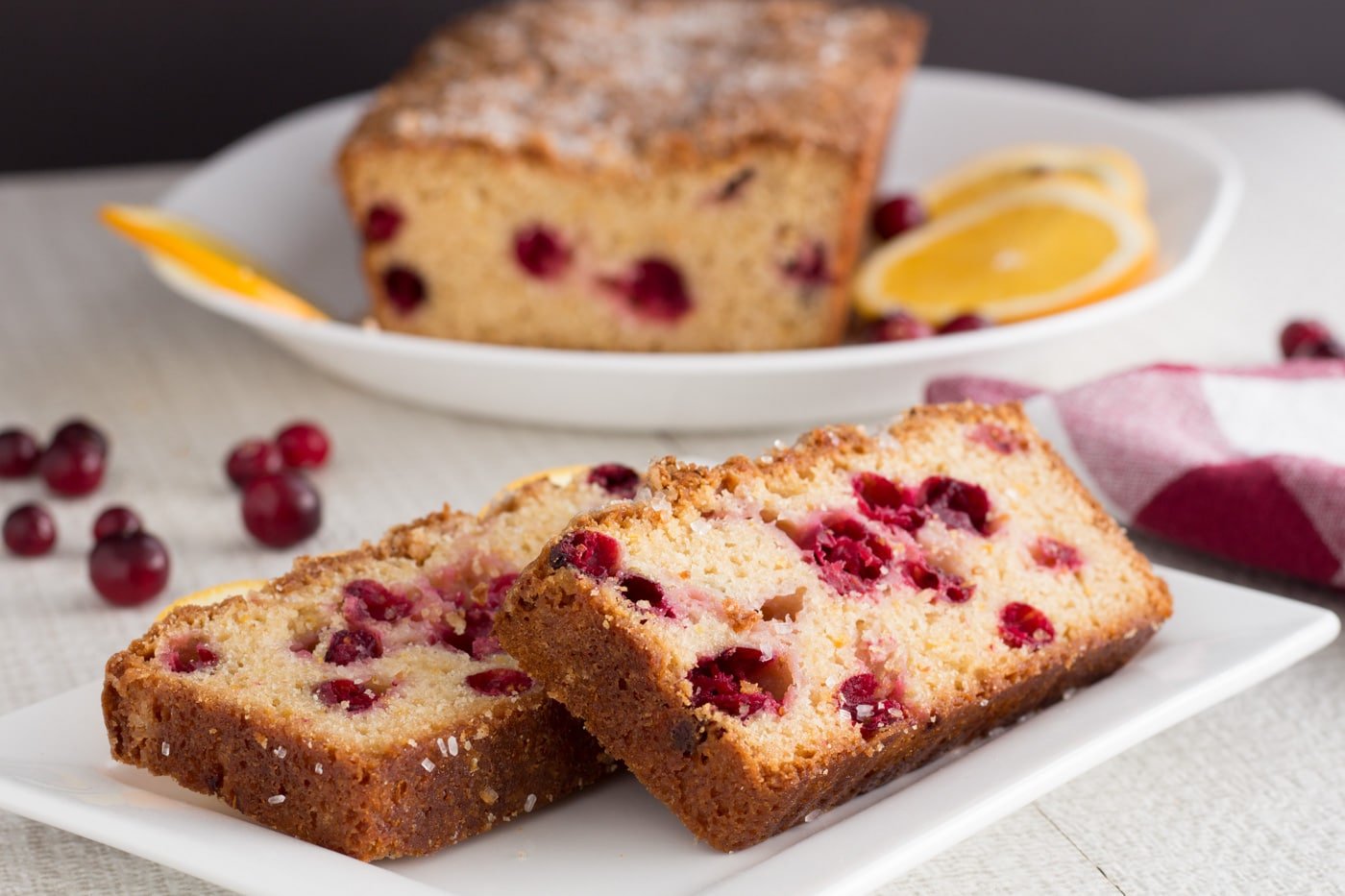 Slices of quick bread with cranberries on a plate