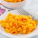 Yellow Rice on a plate with a fork
