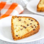 Chocolate Chip Pound Cake slice on a plate with an orange napkin