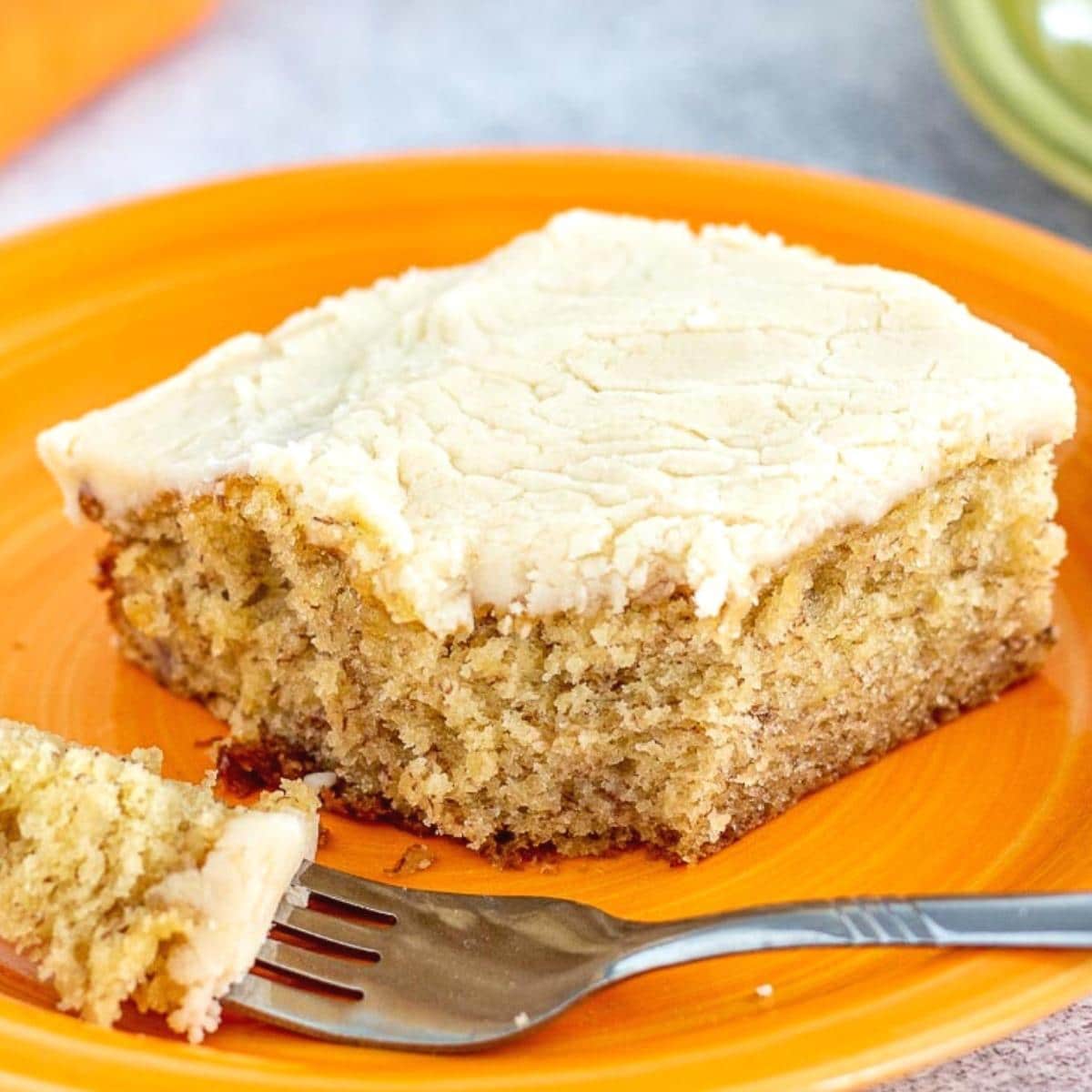 Frosted Banana Brownie on an orange plate with a fork