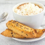 chocolate chip biscotti on a plate with a coffee drink