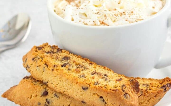 chocolate chip biscotti on a plate with a coffee drink