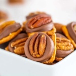 Pretzels topped with whole pecans and soft caramel filled chocolate candies