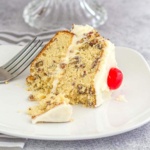 Slice of layered nut cake on a plate