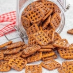 Cinnamon sugar coated pretzels in a glass jar with a red ribbon in the back