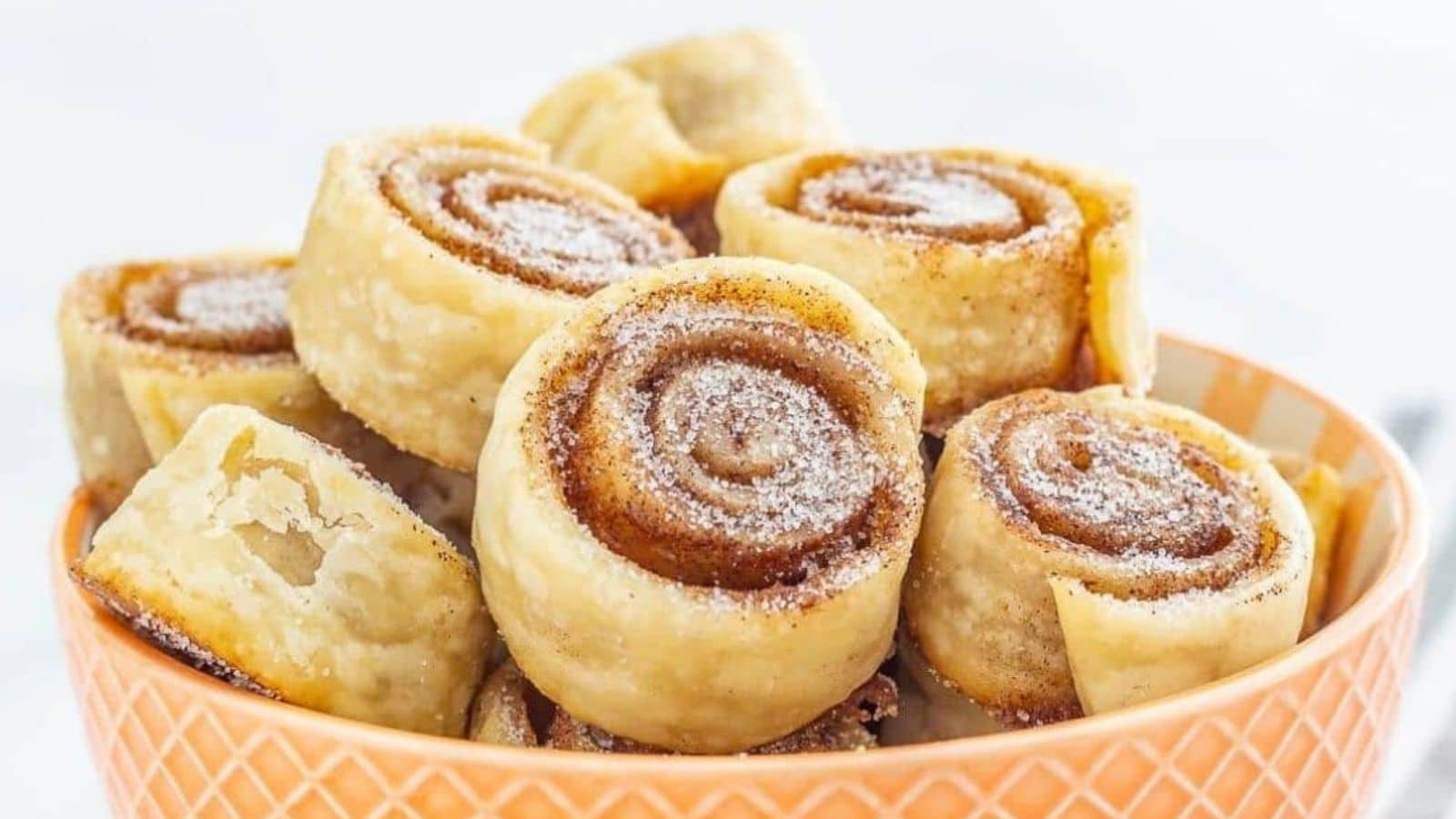Cinnamon Sugar Pie Crusts rolled into cookies in a bowl