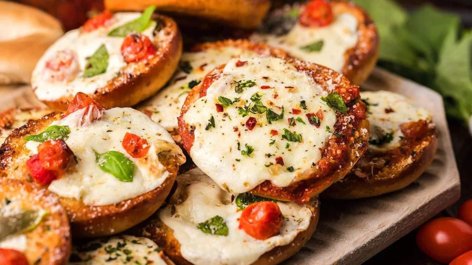 Mini pizza bagels stacked on a serving tray