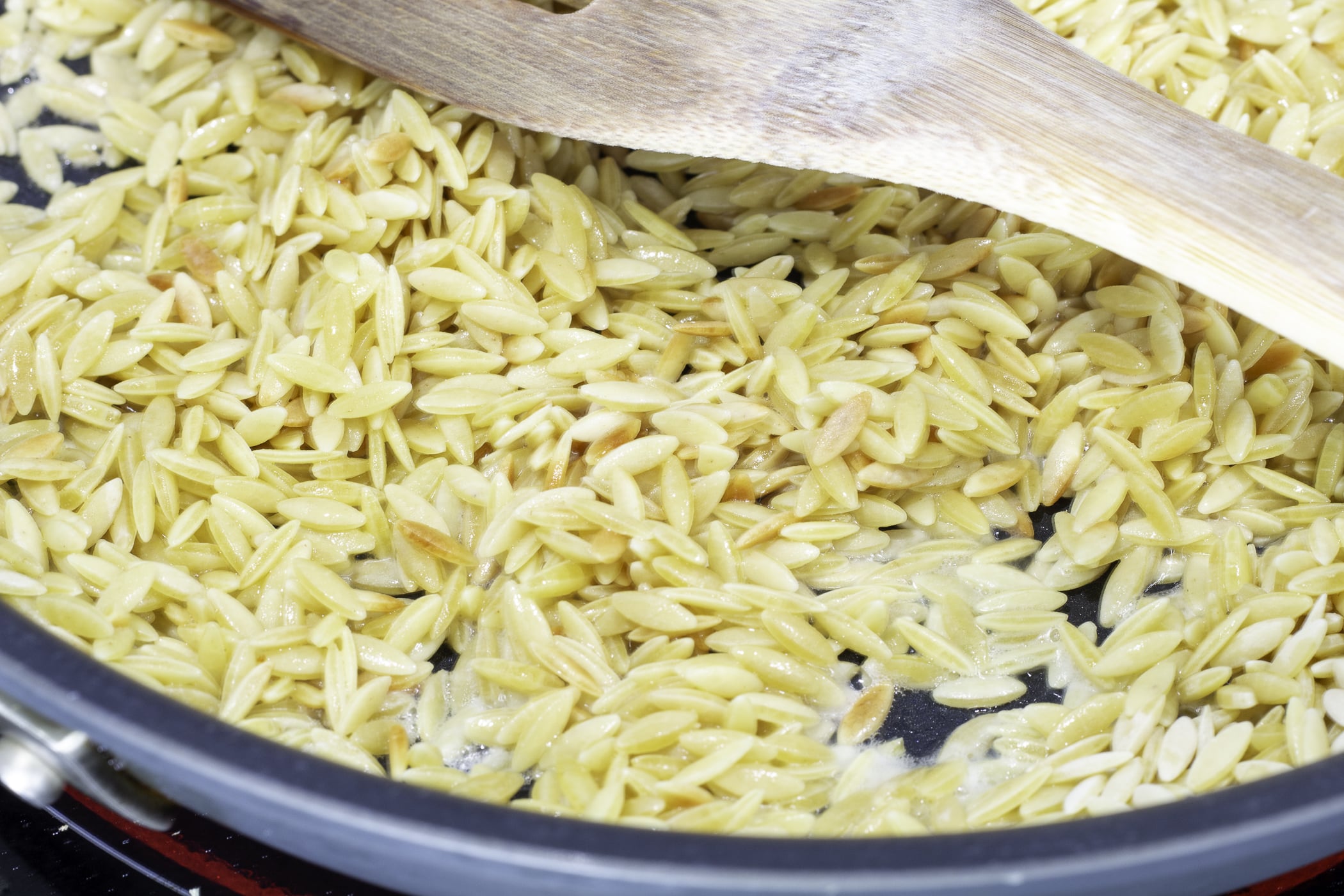 Pasta cooking in butter in a skillet