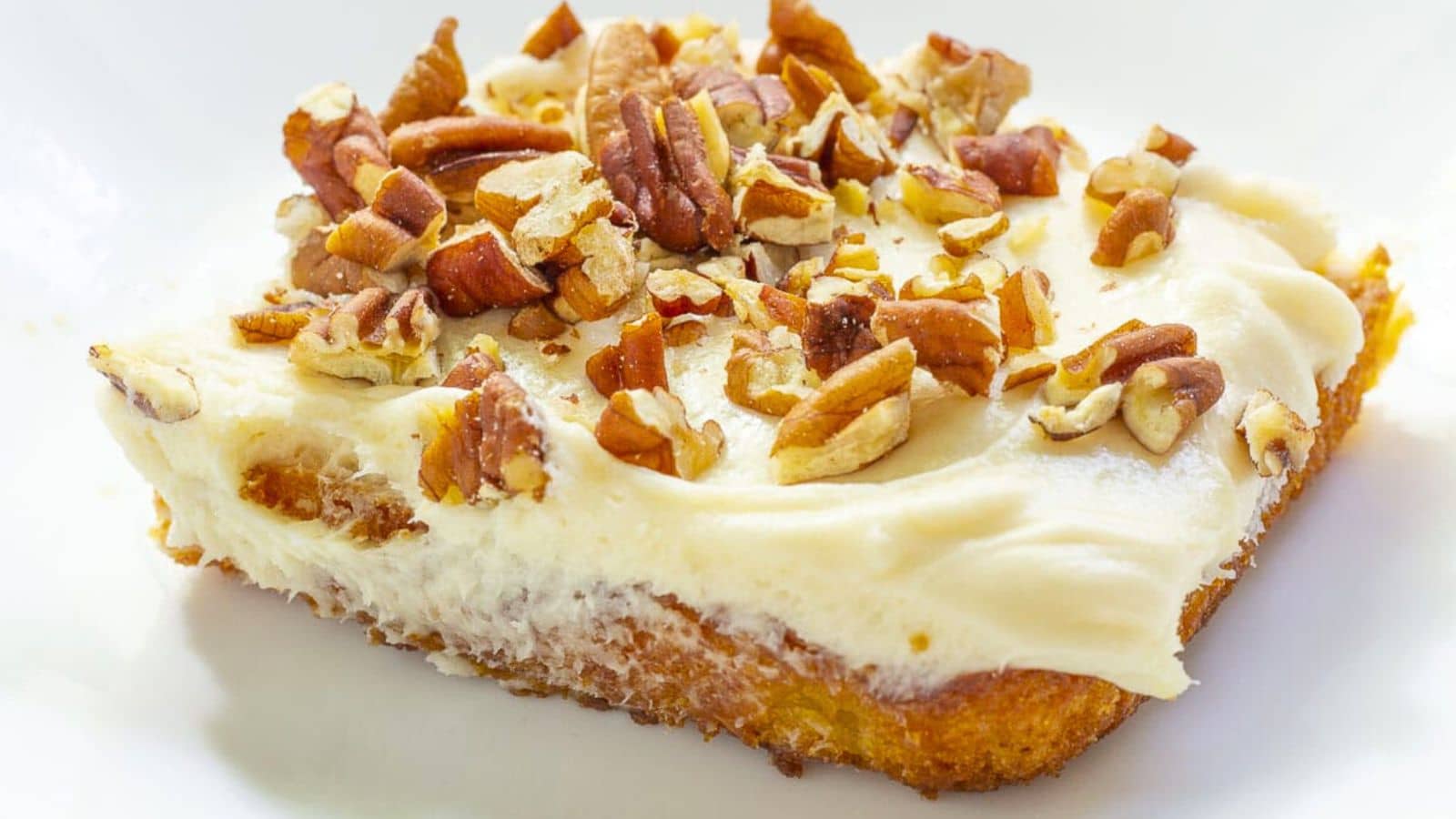 Iced cake topped with nuts