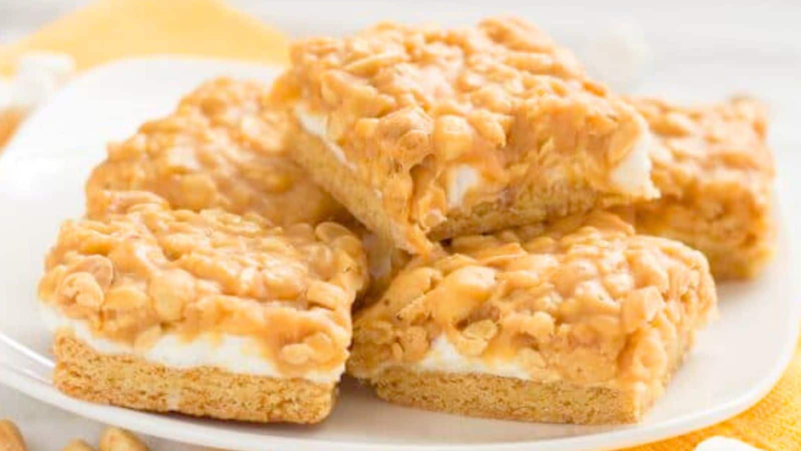 cake layer topped with marshmallows and peanut layer