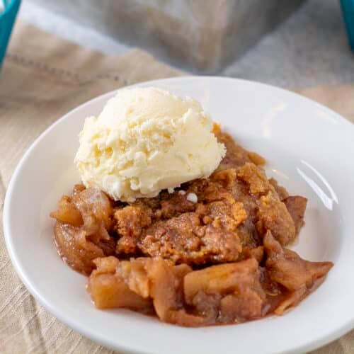 apple crumble on a plate with ice cream