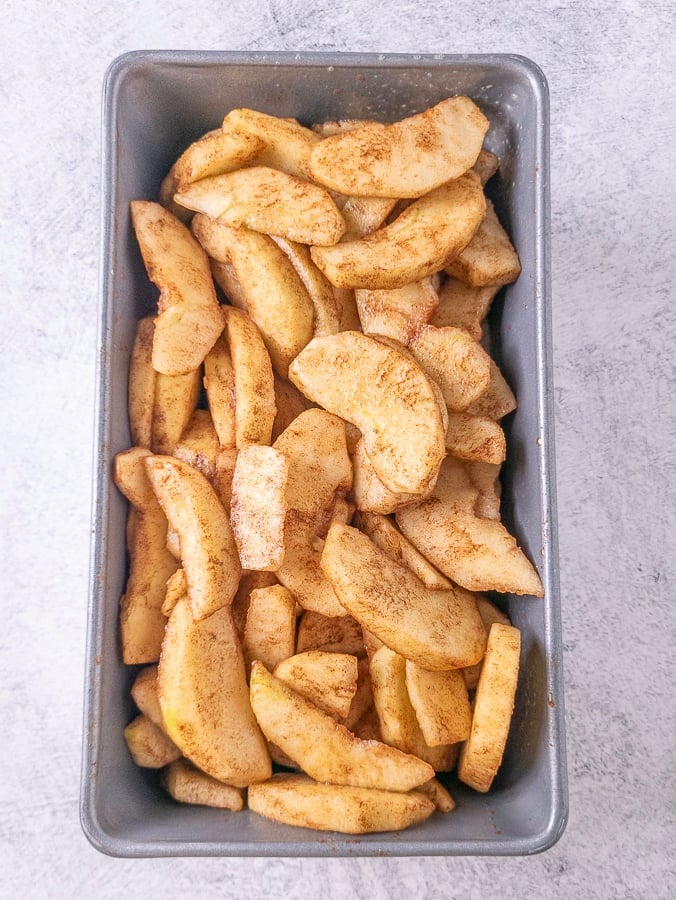 cinnamon sugar coated apples in a loaf pan